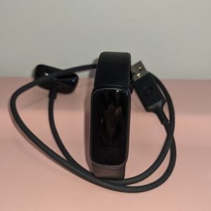 Black Fitbit Luxe Fitness Tracker with Charger